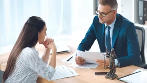 A personal injury lawyer and client at a desk preparing for personal injury mediation.