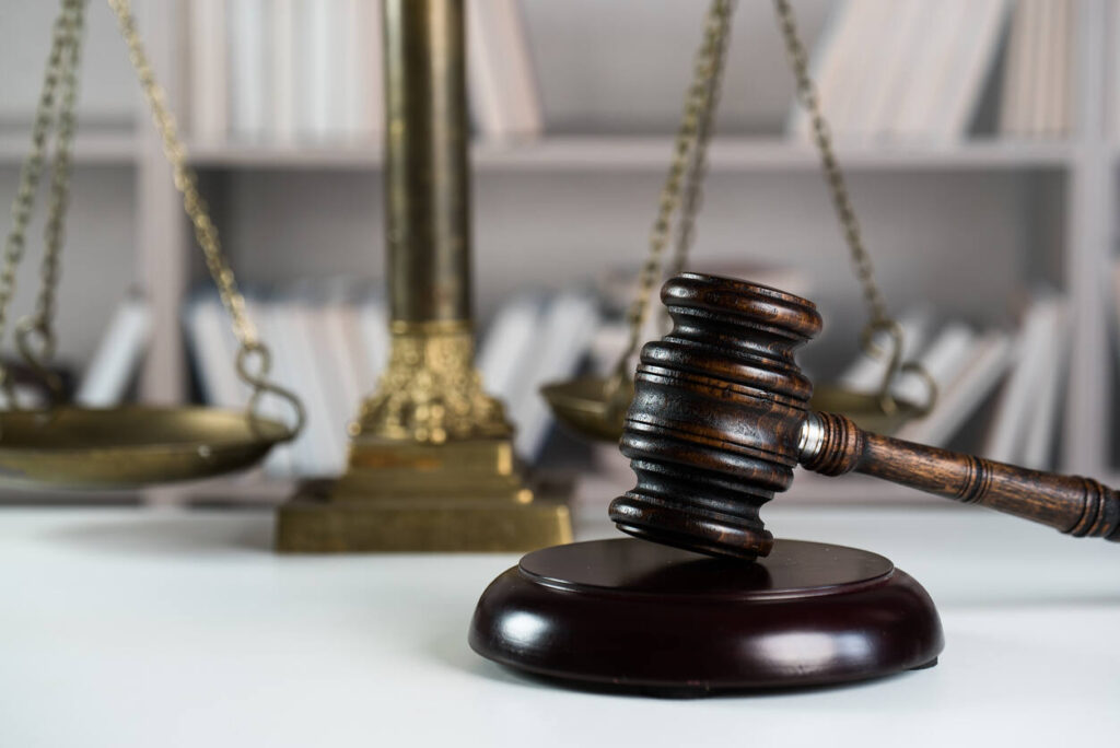 Symbols of law and justice: a wooden gavel and balance scales, relevant for legal representation in premises liability accidents in Chicago.