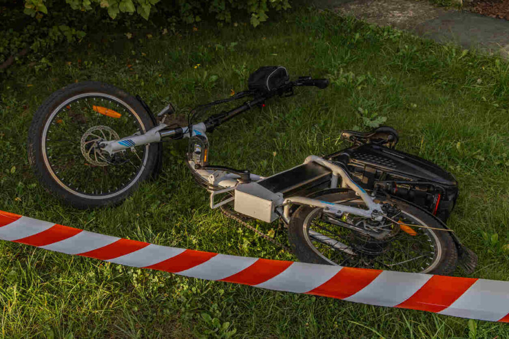 An accident on an electric bicycle, the area secured by the police with red and white protective tape