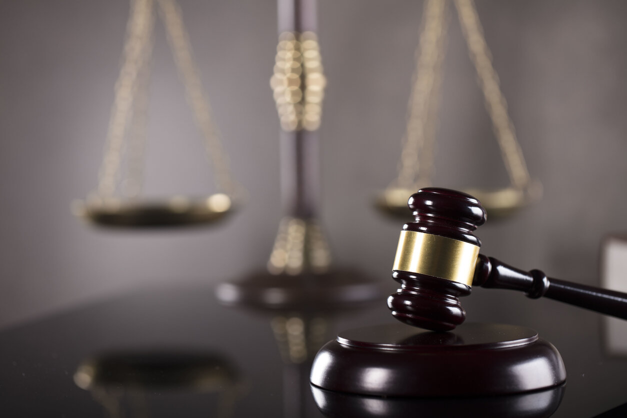 lawyer gavel and scale of justice on the table , representing work place injury lawyer